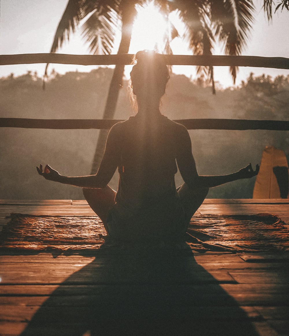 Man stretching outdoors at sunrise in calm park